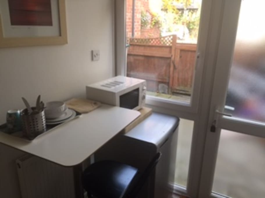 Kitchenette with fridge, microwave, crockery, kettle