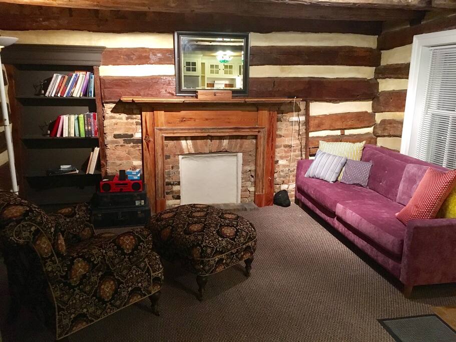 Living room with great sleeping/napping couch and reading chair