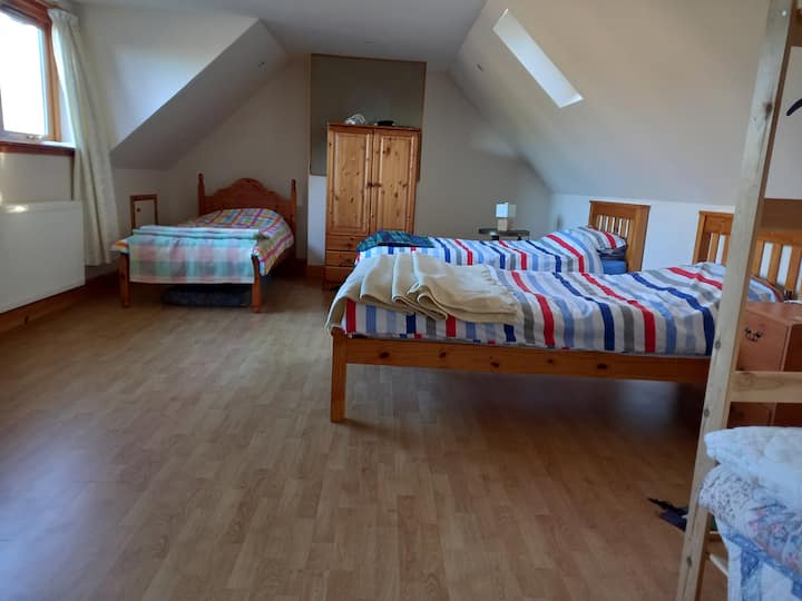 Three single beds and floor mattress (just out of frame)