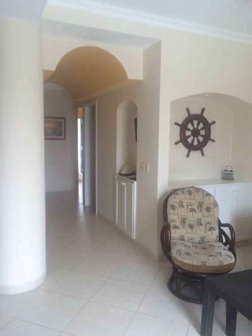 Parte de la sala y pasillo que conduce a los cuartos y a la salida