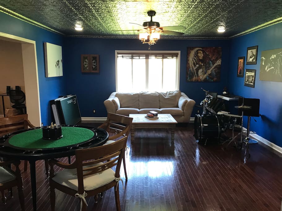 Rec room with a variety of instruments, poker table, ping pong table, dart board, and cards & games