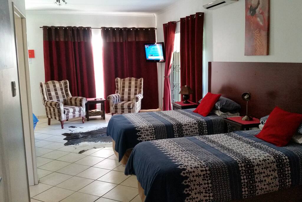 Two single beds, sitting area and TV. Double doors to garden