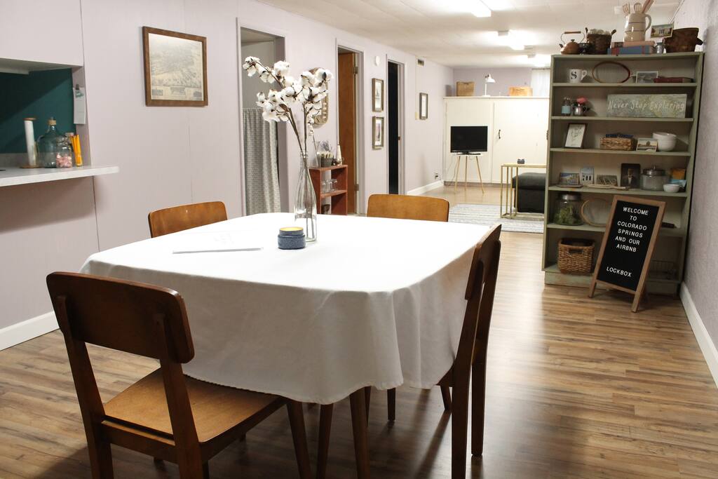 Large living space including a dining area that seats four.