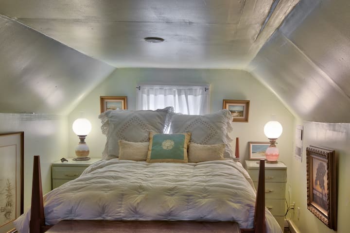 Upstairs loft double bed covered in cozy high thread count Egyptian cotton sheets