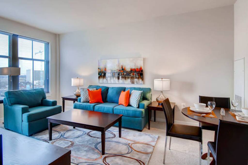 Comfortable living room with pullout sofa bed and club chair