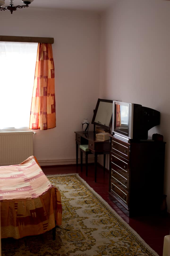 Bedroom Two: Dark wood furniture, natural lighting, facing quiet street. 400cm x 430cm