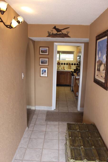 Foyer. To the right, 3 bedrooms and 2 bathrooms. To the left, living room. Straight ahead, the kitchen.