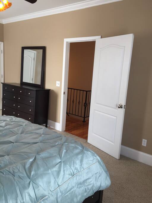 Queen bed in a spacious carpeted bedroom!