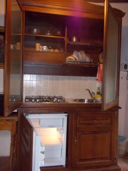 Concealed kitchenette in a tuscan style dresser sideboard