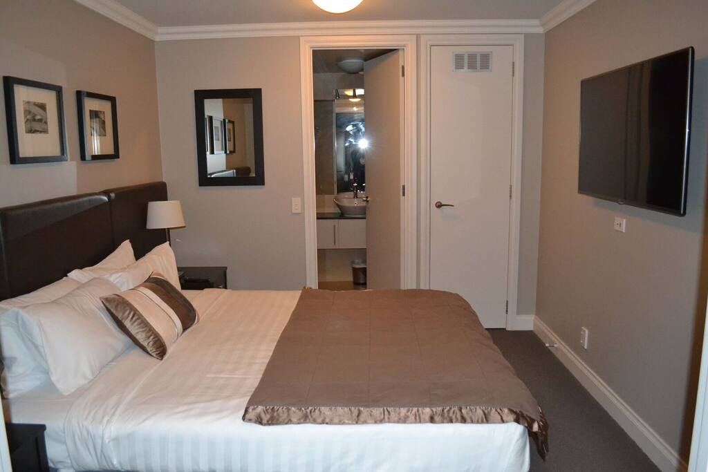 Double bedroom, with ensuite bath, shower, basin and toilette, underfloor heated tiles. TV.