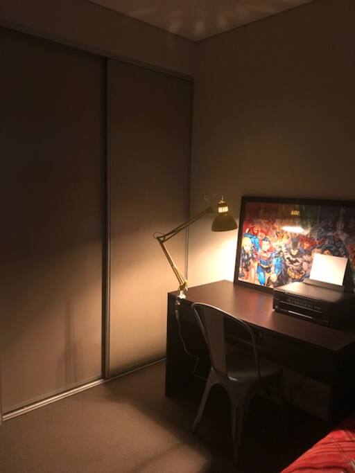 Workspace within bedroom with work lamp