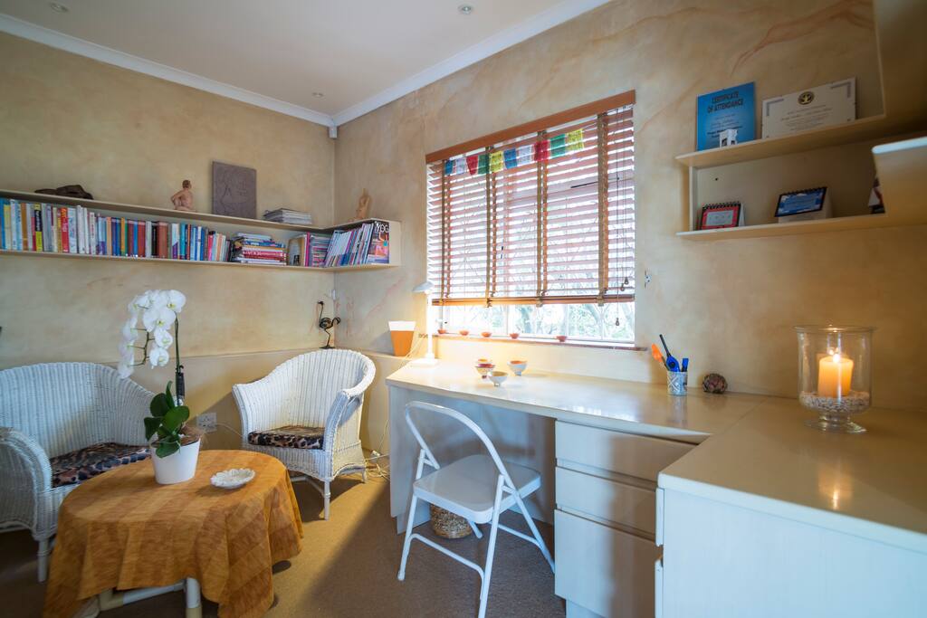 Private bedroom with desk space and sitting area