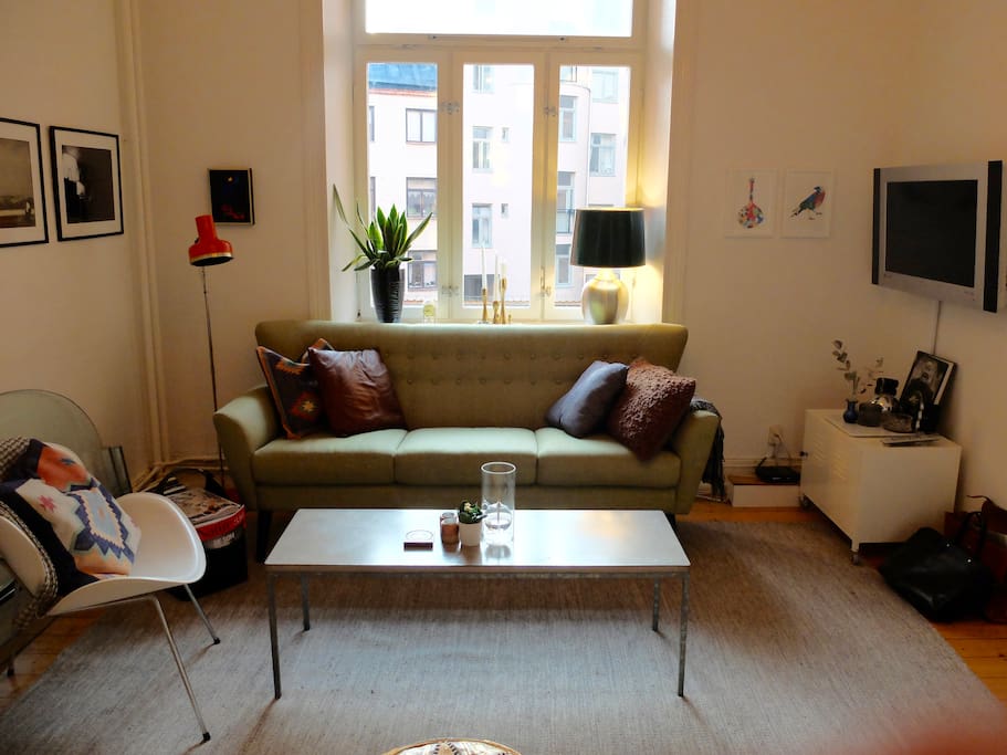 Living room with TV and music speakers.