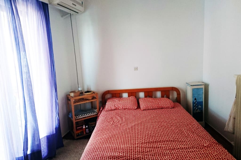 Bedroom with double bed air condition and balcony view