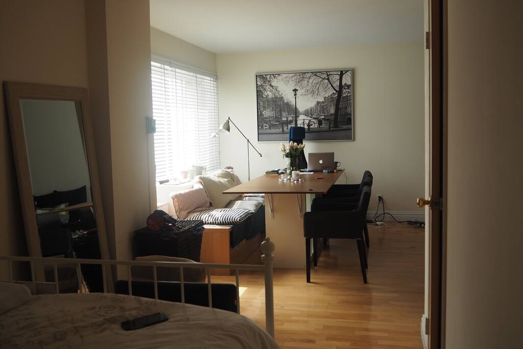 L-Shape Studio with a reading area, living room, dining room and the bedroom space tucked away.
