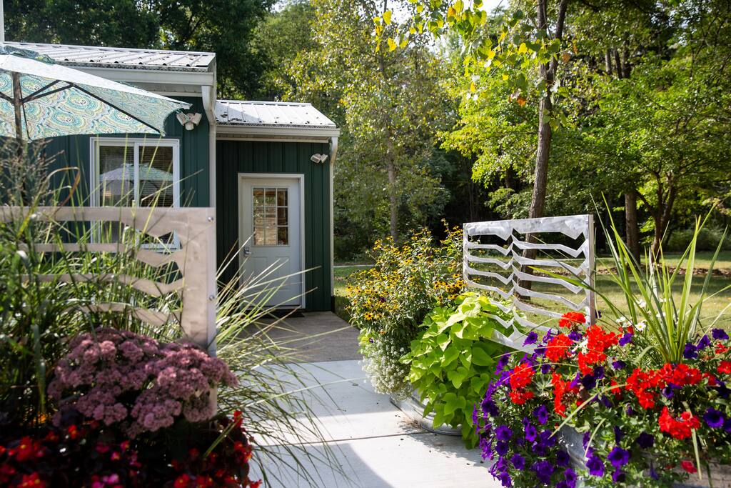 Custom privacy patio screens and beautiful flowers welcome you.