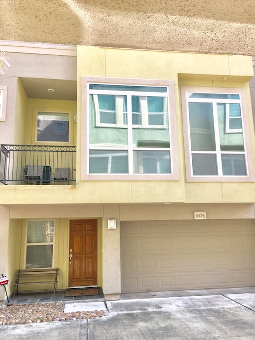 Three story townhouse with 2 car garage and balcony