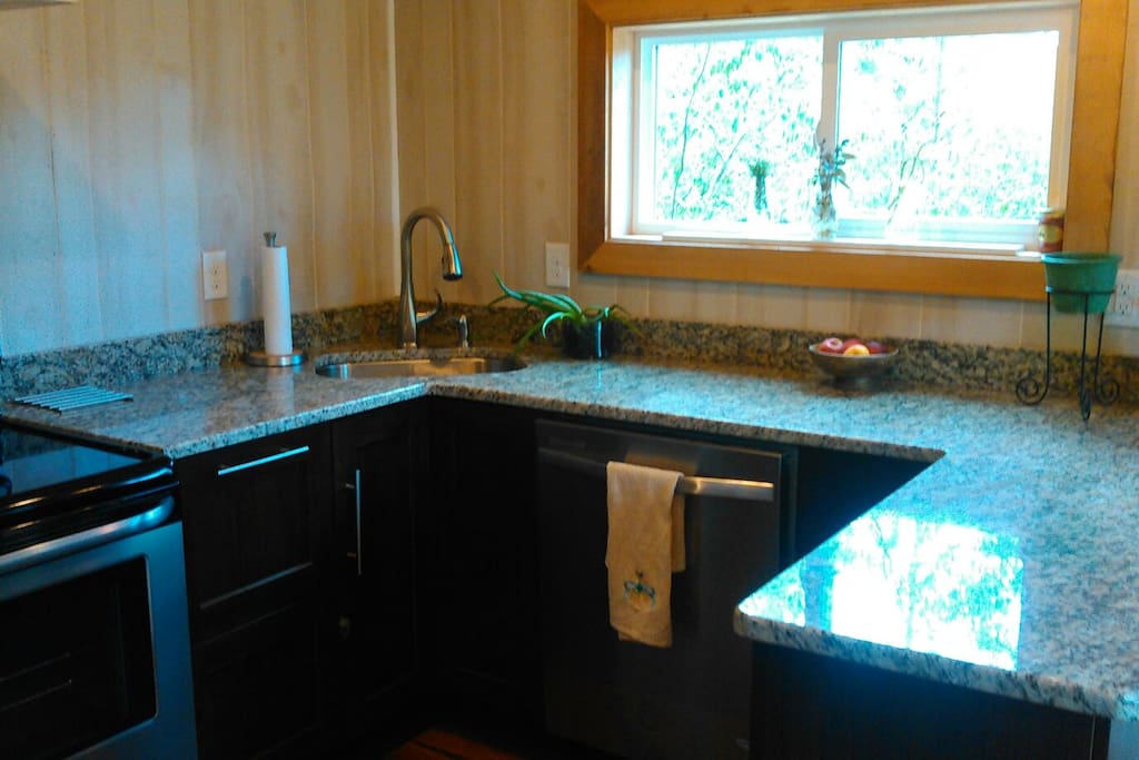 Kitchen has granite countertops, and all stainless steel appliances, range and hood, refrigerator, dishwasher, microwave.