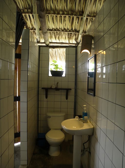 Private bathroom with new appliances and shelving to store your personal belongings.