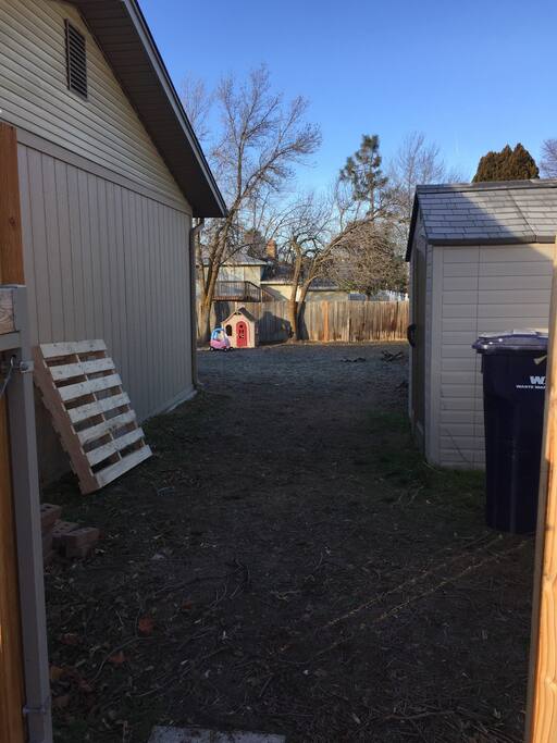 Continue walking past the shed to the end of the house
