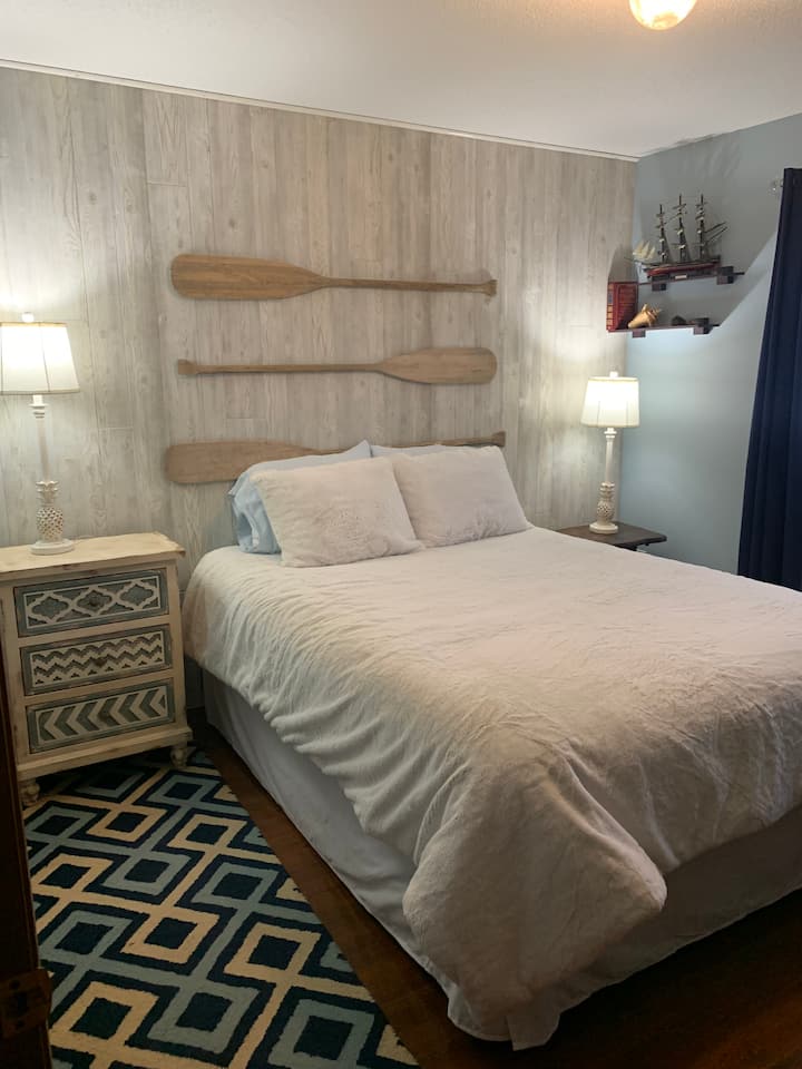 Bedroom 1 has queen sized bed with soft Ugg comforter and beautiful views of the lake. It also had a large closet with hangers, a dresser and nightstands for storage.  There is a TV with Roku and a DVD player.