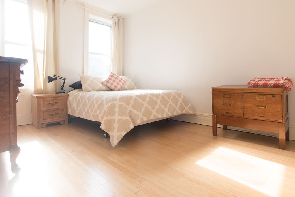 Master bedroom with queen size bed and antique wood dressers