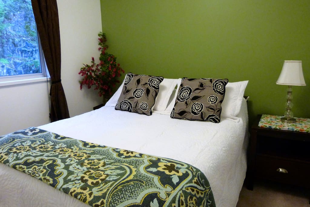 Your quiet, garden-facing room with a very comfortable queen-sized bed.
