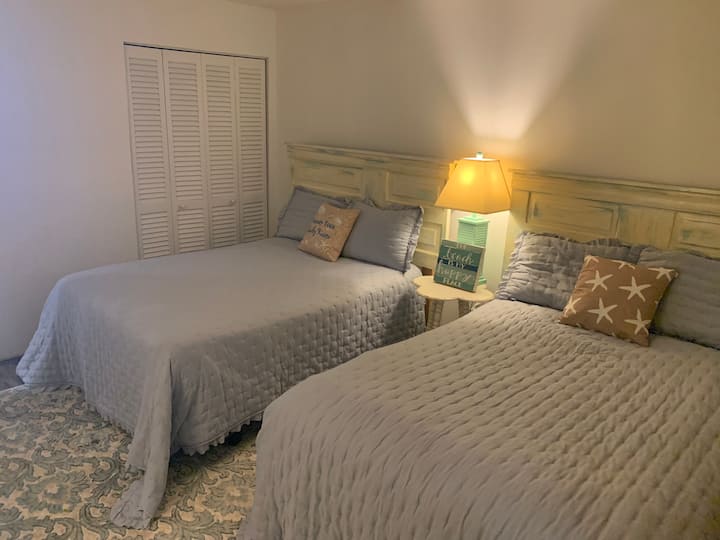 The 900 sq.ft. condo is stocked with fresh linens for all beds, including those in this cozy, cottage room offering quiet respite for a nap or kids to just chill. Empty closets and dressers provide excess storage for your belongings.