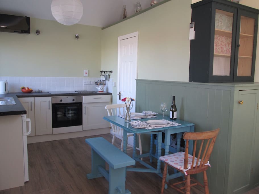 Kitchen/dining area with door leading to shower/bathroom