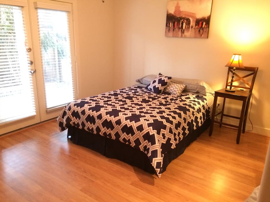 One of two 1st floor guest bedroom with queen bed (largest of the two bedrooms) with DVD capable TV (no cable connection) and patio access.