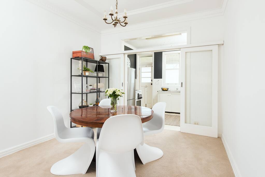 dining room with lovely antique mahogany dining table and Panton S chairs is quirky and fun.