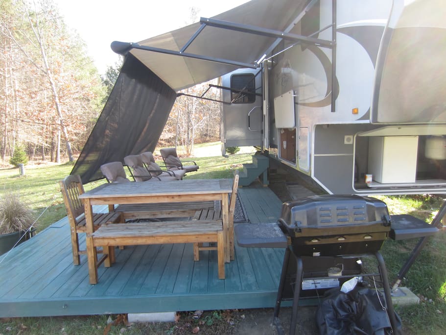 Large deck with seating to watch TV or enjoy a meal from the gas grill.