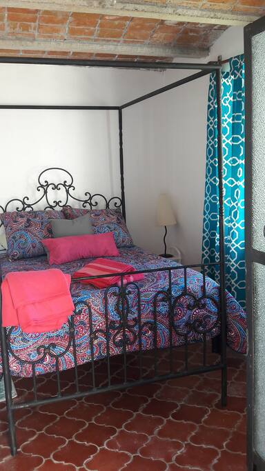 Heirloom canopy bed and exposed brick for a romantic place to dream.
