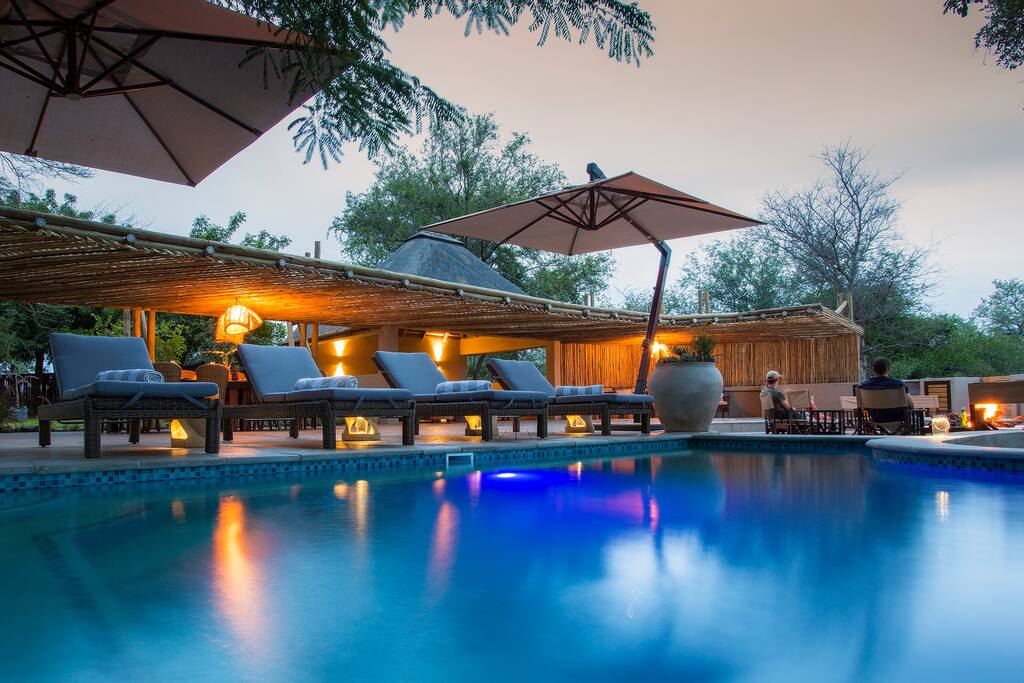 The bar and entertainment area lie only meters away from a high-traffic watering hole, adjacent to a dry riverbank.
The entertainment area consists of a sizeable deck, a large pool, an open-air bar and a dining area. The boma provides ambience, and a lovely outdoor braai area.