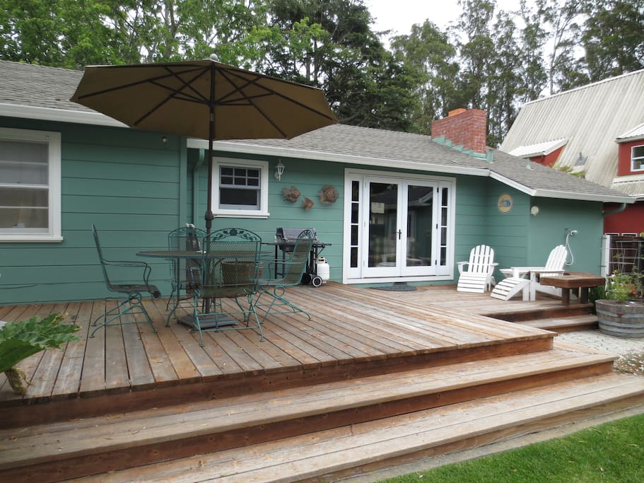 Expansive Backyard with Gas BBQ for Grilling, Outdoor Dining Set and Adirondack Chairs