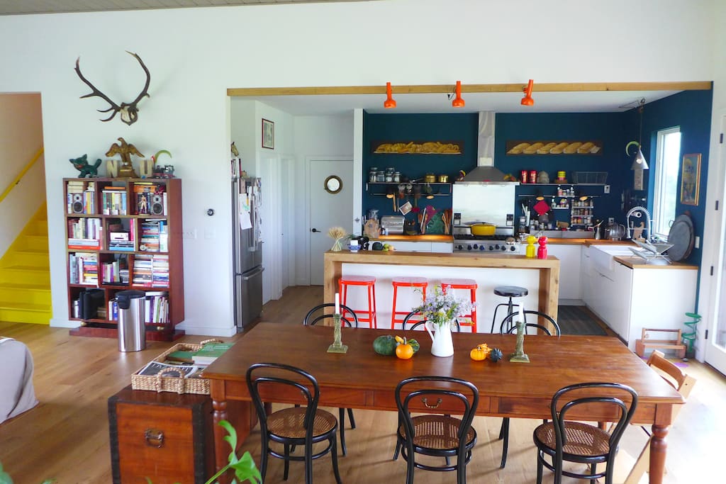 Kitchen, dining room table and stairs going up to attic.