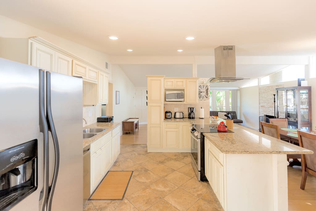 Kitchen with open floor plan tile floors with granite counters and high ceilings.