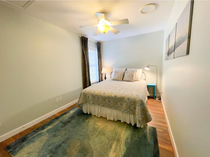 secondary bedroom with ceiling fan and queen bed
