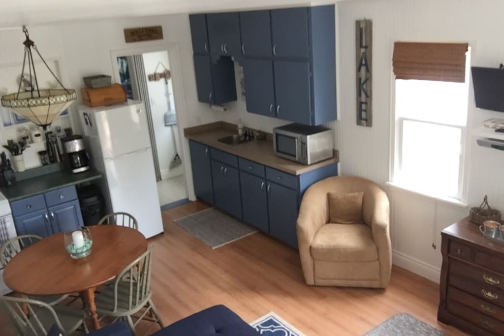 Fully equipped kitchen with all utensils, pots, pans, bowls, plates, glasses, coffee maker, microwave, stove/oven.