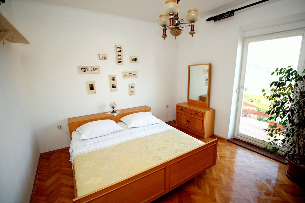 A large double bed, the bed sheets were embroidered by my grandmother