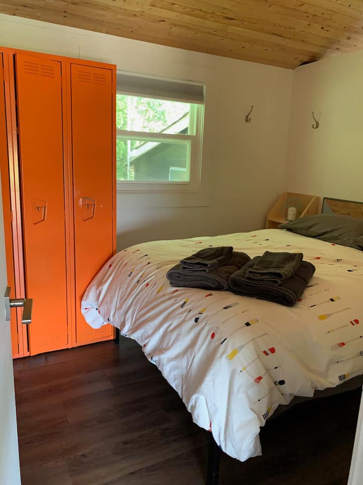 Middle bedroom with double bed and vintage lockers.
Note: Bedroom walls are loft style and do not extend to the open air vaulted ceiling.