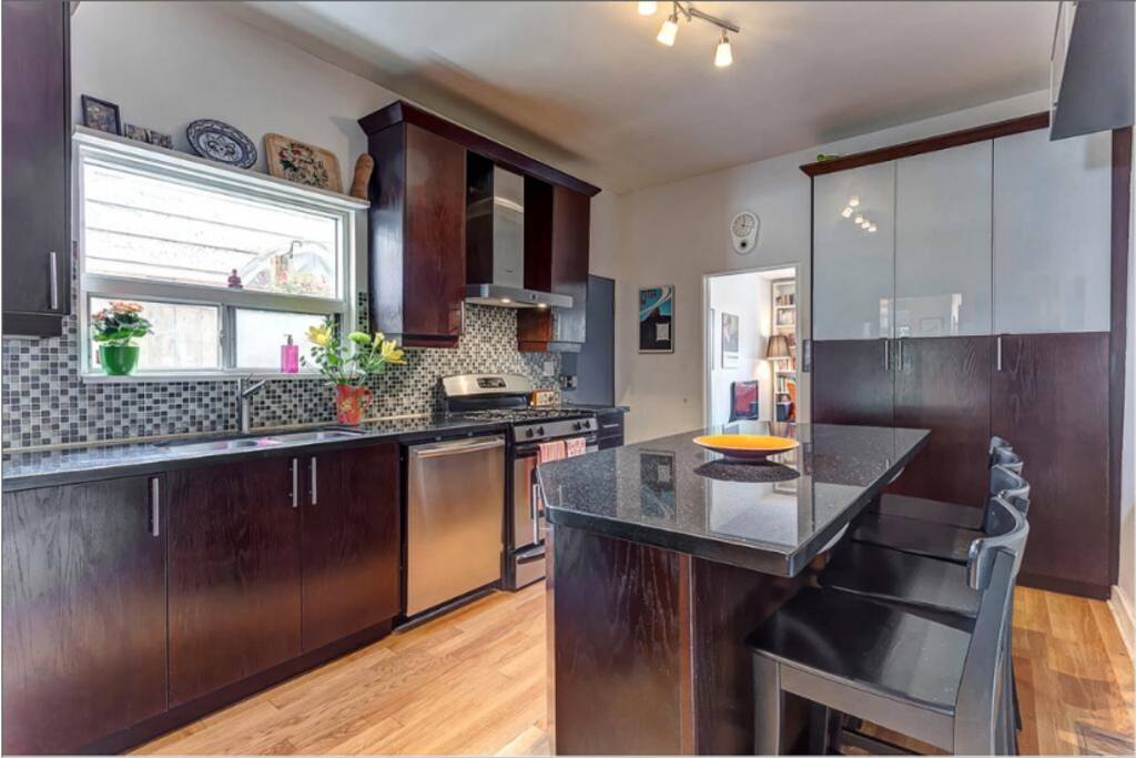 Kitchen has gas stove, dishwasher, microwave, fridge, large granite island.