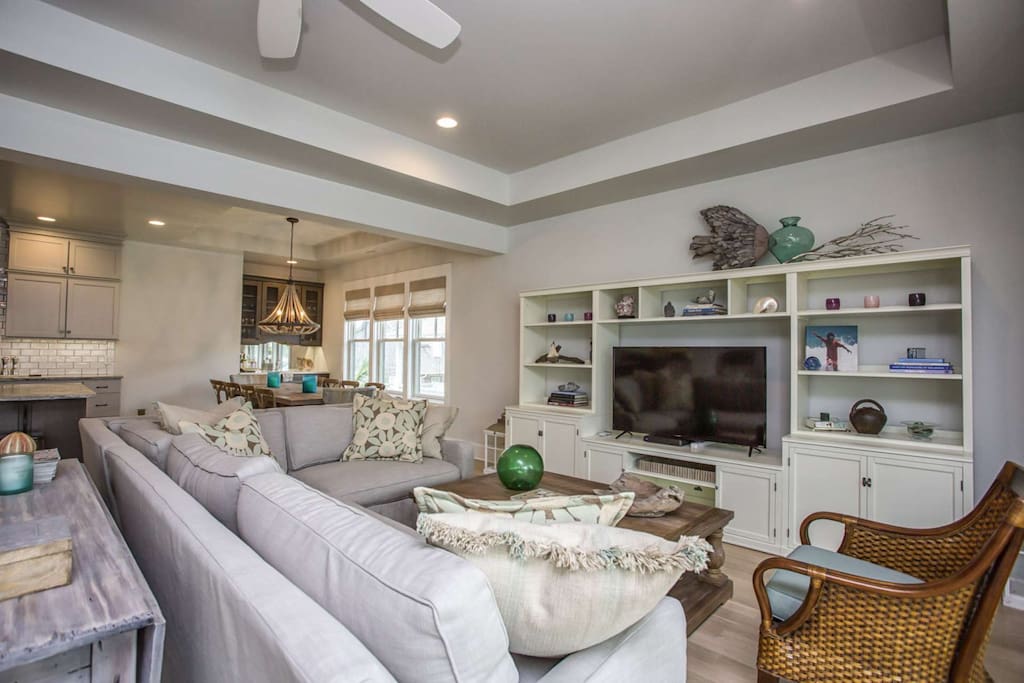 Large screen TV can be seen from the kitchen or while lounging on the spacious and comfy sofa
