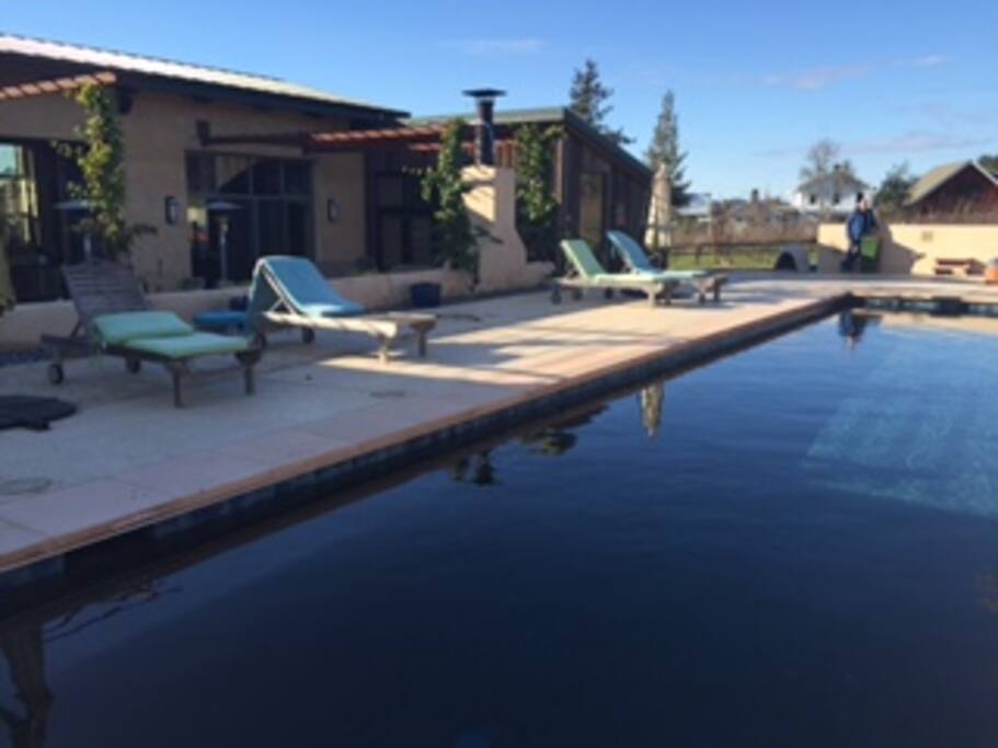 comfortable outdoor living space including hot water shower, fireplace, bbq and sink, food prep area