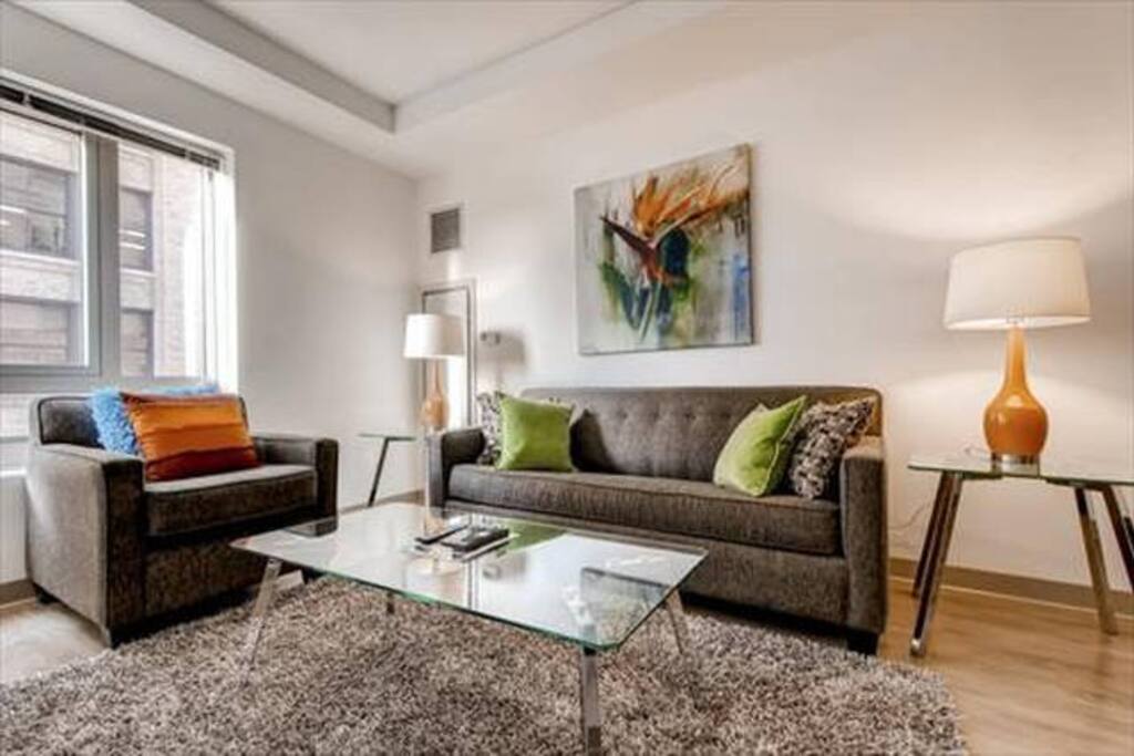 Comfortable living room with pullout sofa bed and club chair