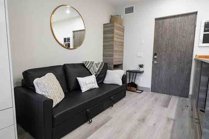 Диванът се изтегля в легло с много възглавници и одеяла 