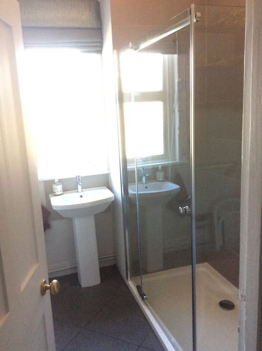A bathroom just for the guests, towels provided.
