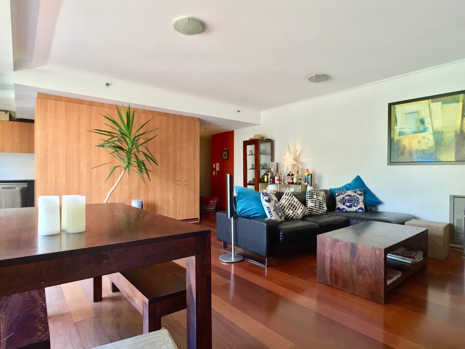 Open plan living dining area with polished floorboards