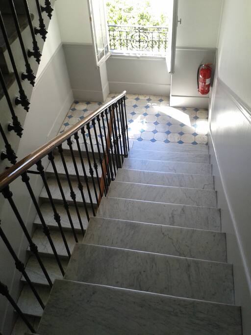 Airy Staircase With Old Tiles and Green Views