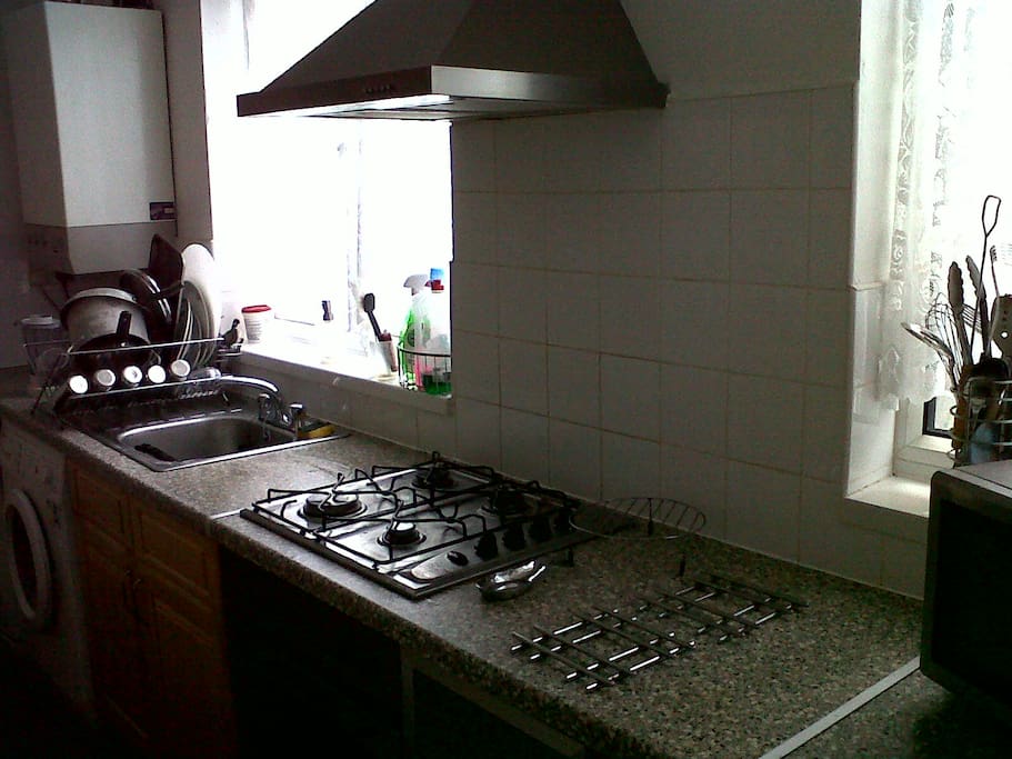 Kitchen with hob, oven, microwave, toaster, kettle, fridge etc